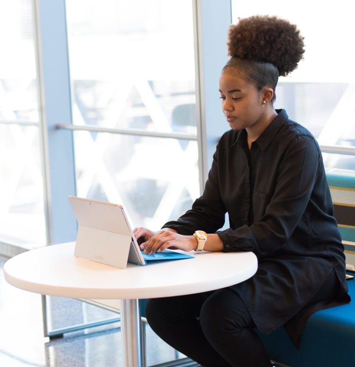 woman typing on tablet