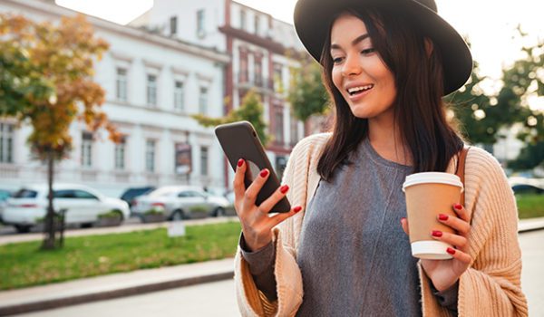 Portrait Of A Pretty Smiling Woman Using Mobile Phone