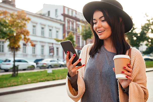 Portrait Of A Pretty Smiling Woman Using Mobile Phone