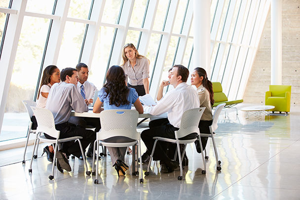 business people sitting and talking around a table