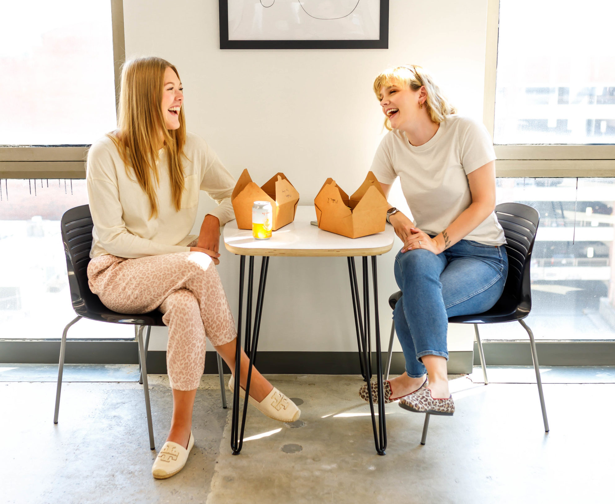 two colleagues laughing over lunch