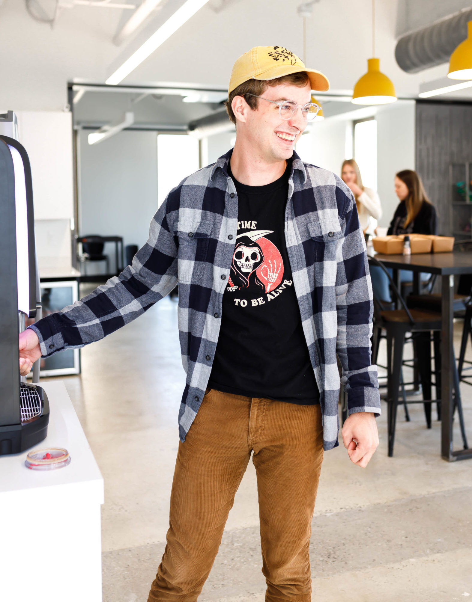 man getting coffee in an office breakroom