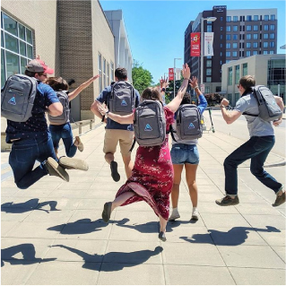 Go Fish team members jumping outside Raleigh office