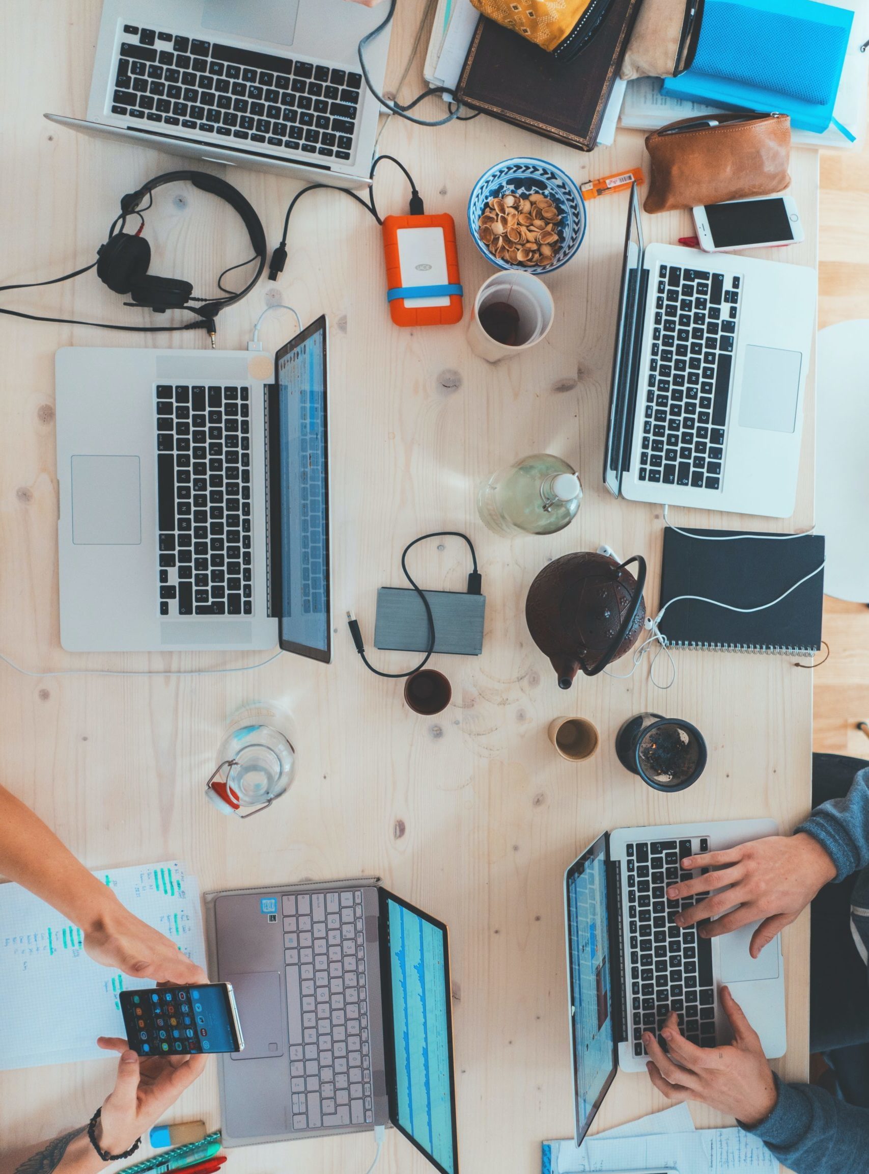 aerial shot of laptops on messy desk