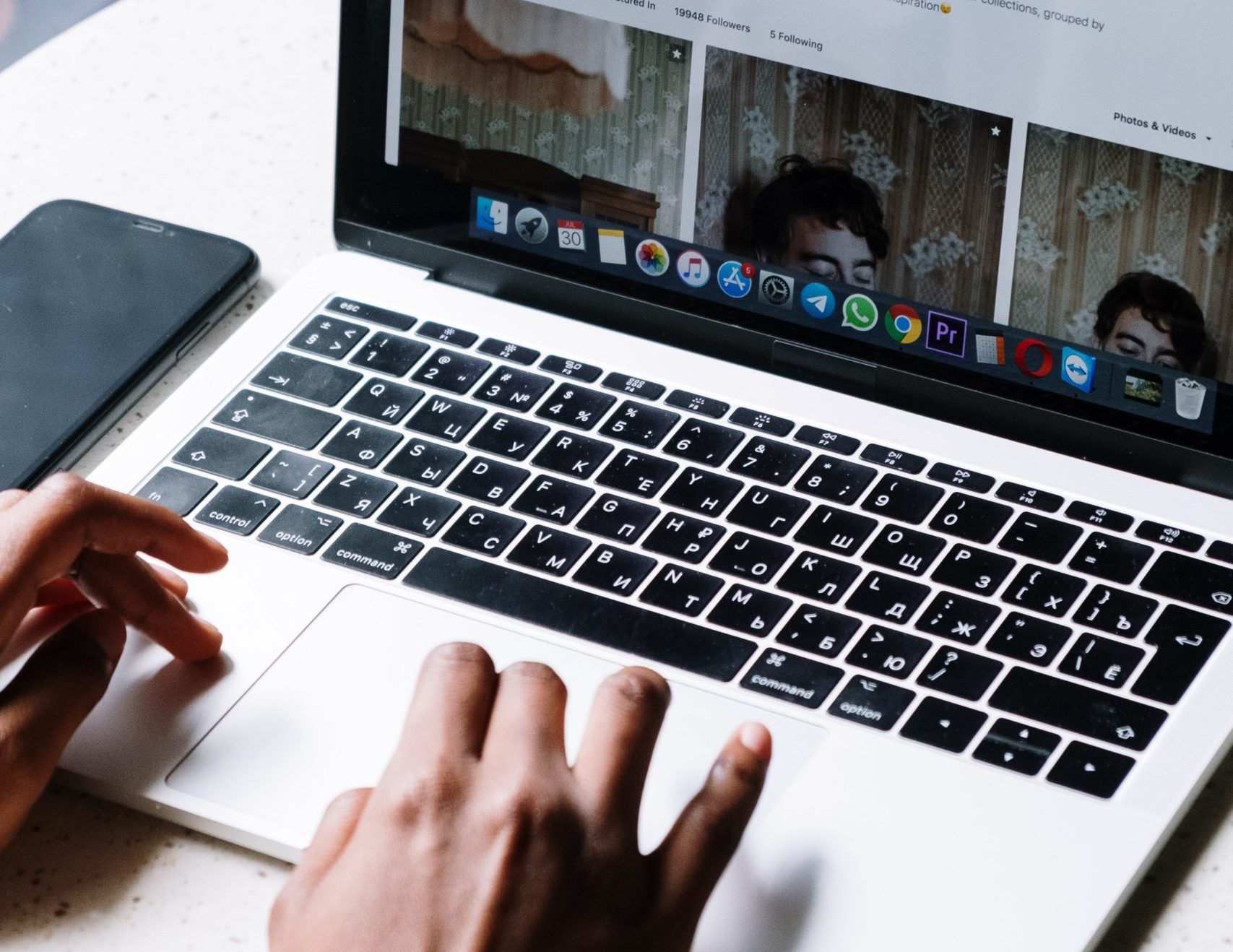 person browsing macbook