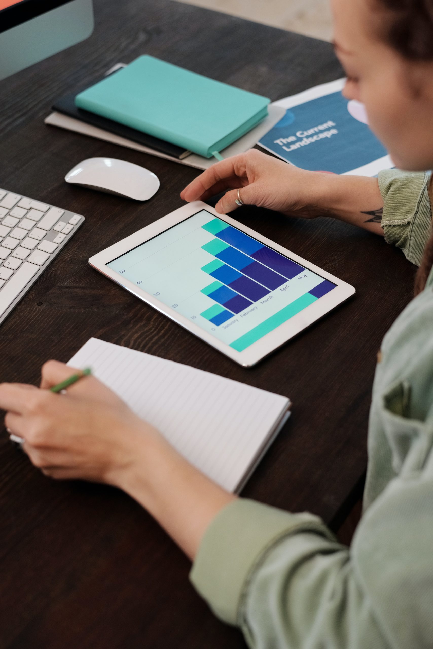 woman reviewing charts on her tablet