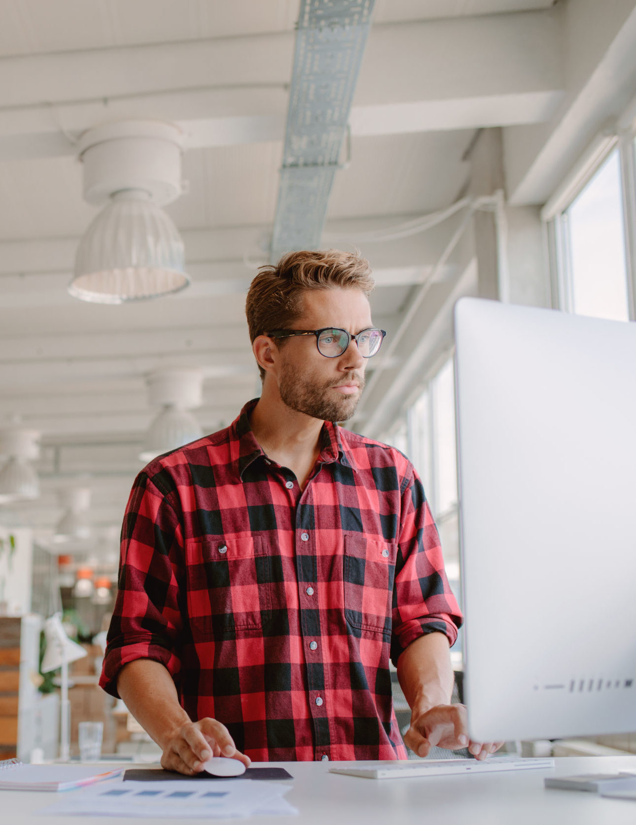 man standing and using mac